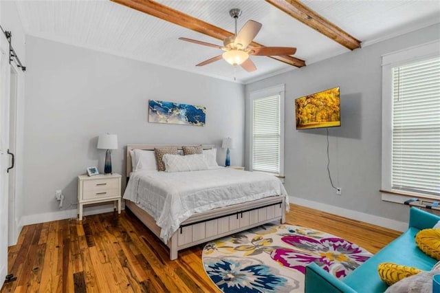 bedroom with ceiling fan, crown molding, beamed ceiling, and dark wood-type flooring