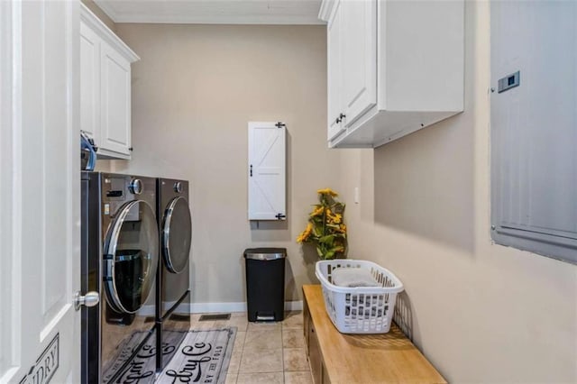 clothes washing area with light tile patterned flooring, cabinets, and independent washer and dryer