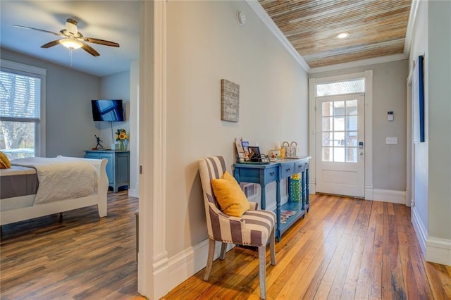 interior space with crown molding, ceiling fan, dark wood-type flooring, and wooden ceiling