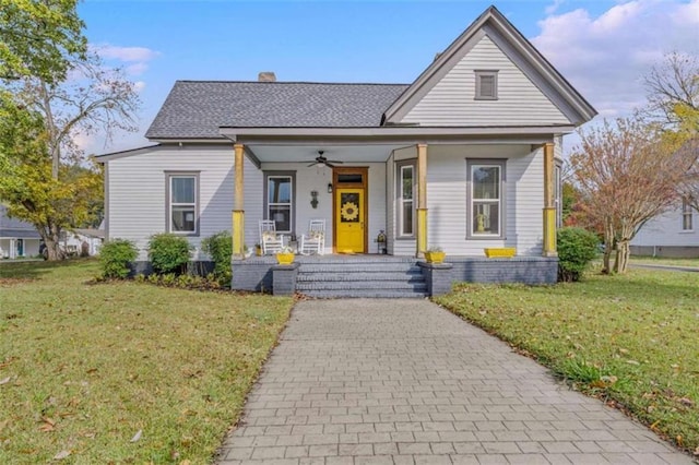 bungalow-style home with a porch and a front lawn