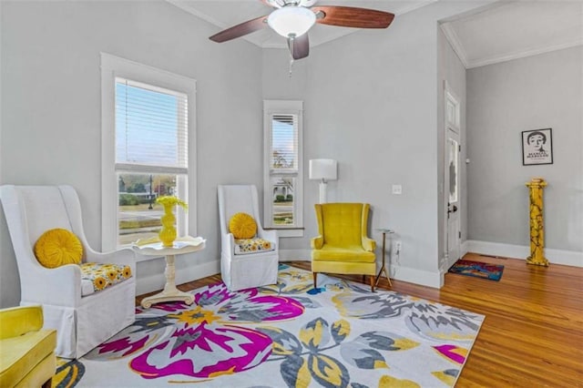 sitting room featuring ceiling fan, hardwood / wood-style floors, and ornamental molding