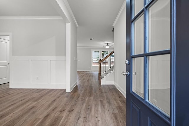 foyer with hardwood / wood-style floors and ornamental molding