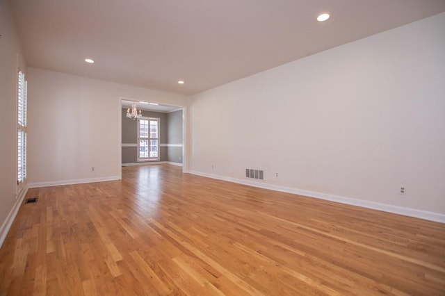 spare room with a chandelier, visible vents, recessed lighting, and light wood-type flooring