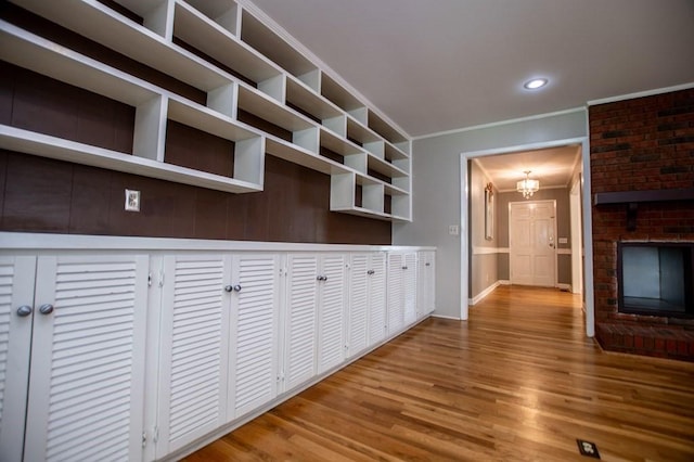 interior space with wood finished floors, baseboards, recessed lighting, crown molding, and a chandelier