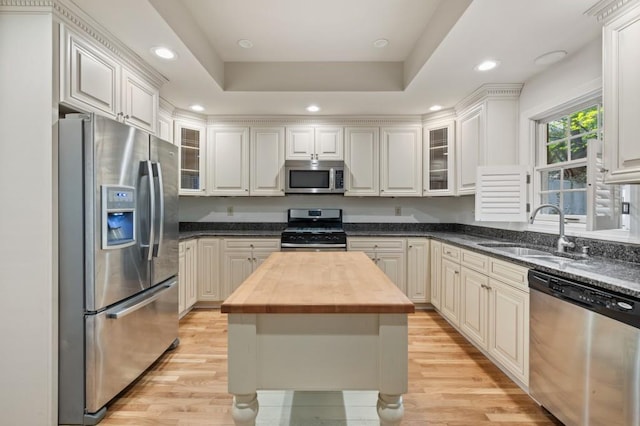 kitchen featuring sink, wooden counters, white cabinetry, and appliances with stainless steel finishes