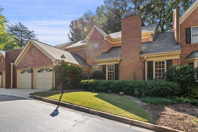 view of front of house with a front yard and a garage