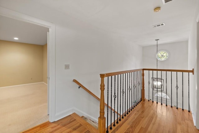 staircase with hardwood / wood-style floors