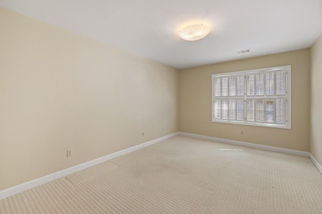 unfurnished room featuring light colored carpet