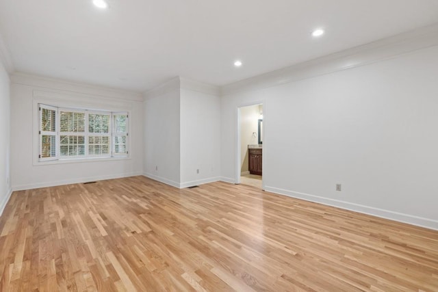 unfurnished room with crown molding and light wood-type flooring