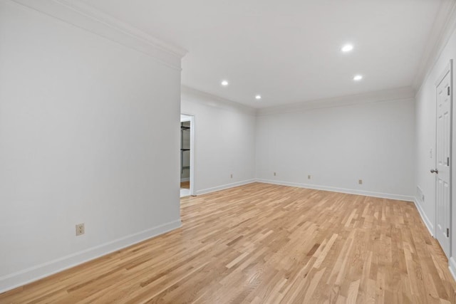 unfurnished room with light hardwood / wood-style flooring and crown molding