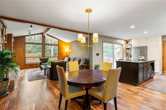 dining room with light wood-type flooring, vaulted ceiling with beams, recessed lighting, and an inviting chandelier