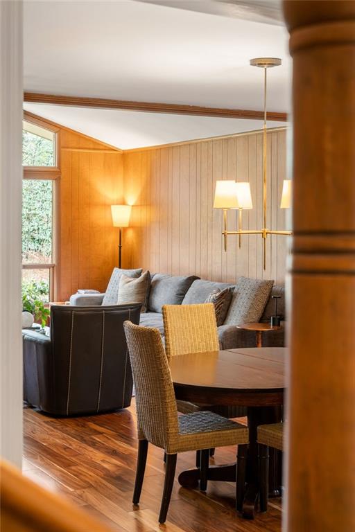 dining space featuring wood walls and wood finished floors