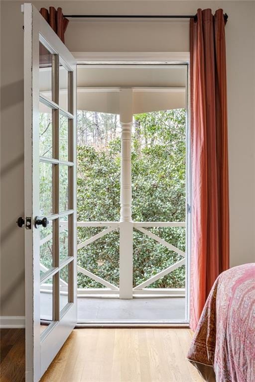 doorway to outside with wood finished floors and a wealth of natural light