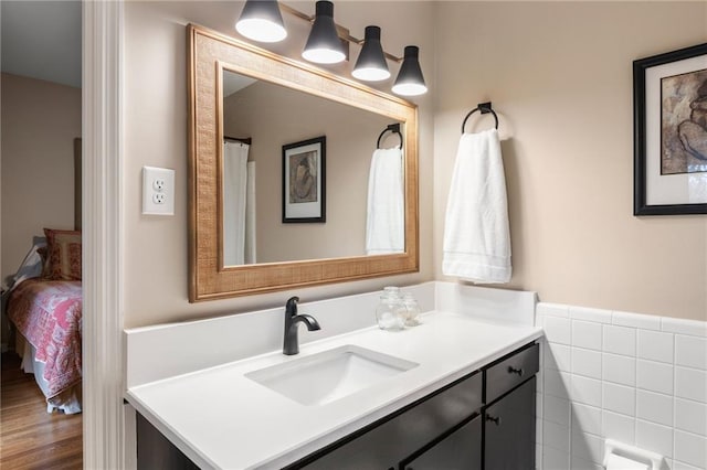 bathroom with tile walls and vanity