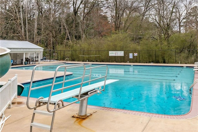 community pool featuring a patio and fence