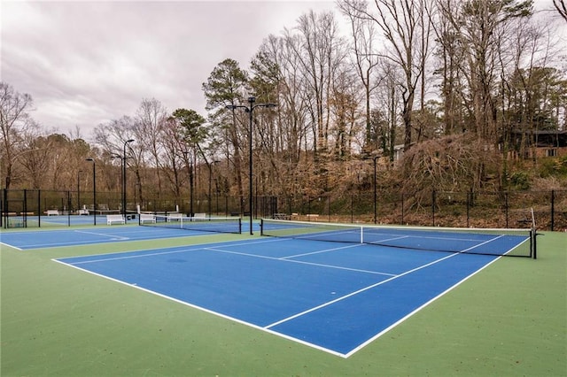 view of tennis court with fence