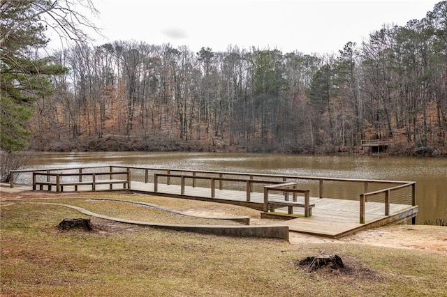 view of dock with a water view and a view of trees