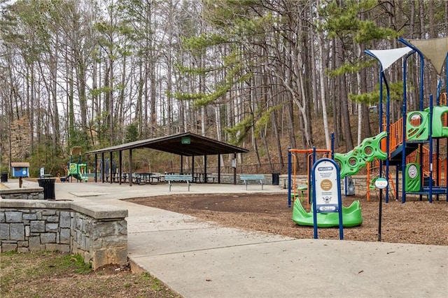 view of home's community with playground community and concrete driveway