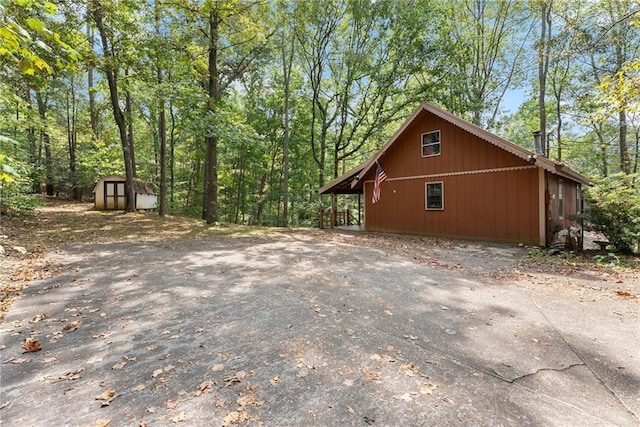 view of home's exterior featuring a storage unit