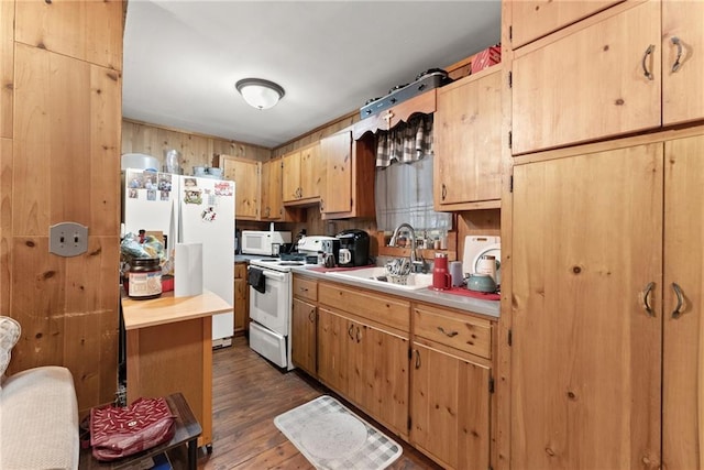 kitchen featuring white appliances, dark hardwood / wood-style floors, light brown cabinetry, and sink