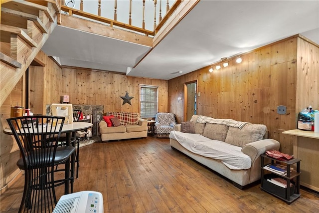 living room with hardwood / wood-style floors and wood walls