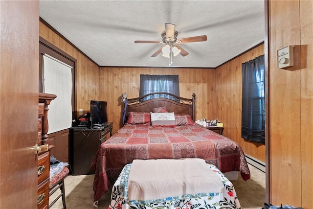 carpeted bedroom featuring crown molding, ceiling fan, baseboard heating, a textured ceiling, and wood walls