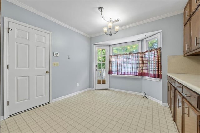 unfurnished dining area with an inviting chandelier and crown molding