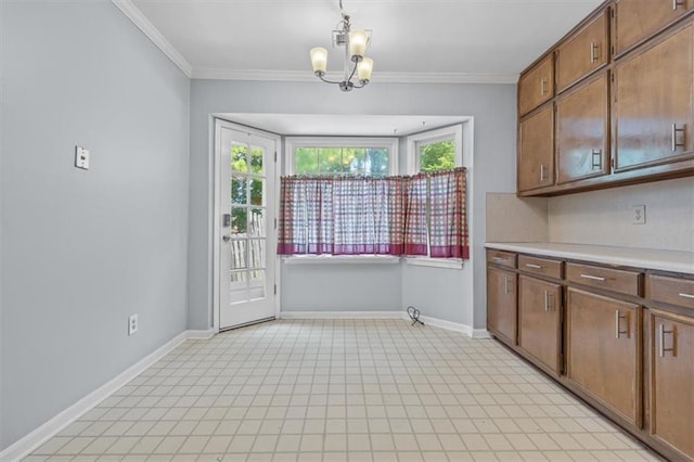 kitchen featuring ornamental molding, pendant lighting, and a notable chandelier