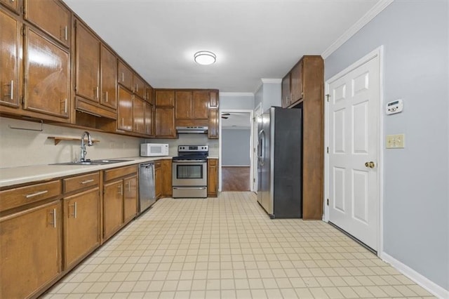 kitchen featuring crown molding, appliances with stainless steel finishes, and sink