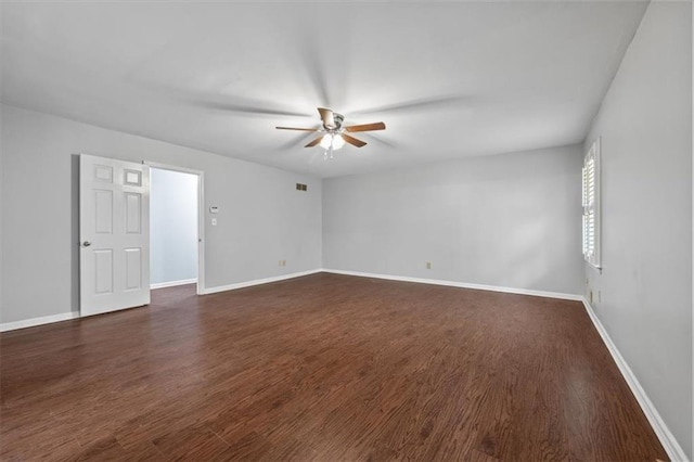 empty room with dark hardwood / wood-style floors and ceiling fan