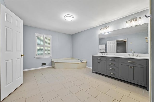 bathroom with vanity, a bath, and tile patterned floors