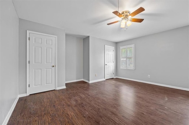 spare room with dark wood-type flooring and ceiling fan