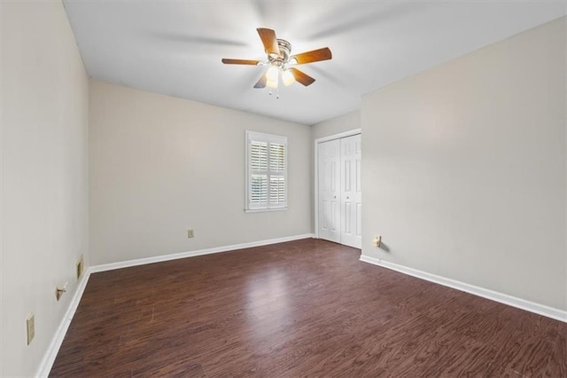 unfurnished room featuring dark wood-type flooring and ceiling fan