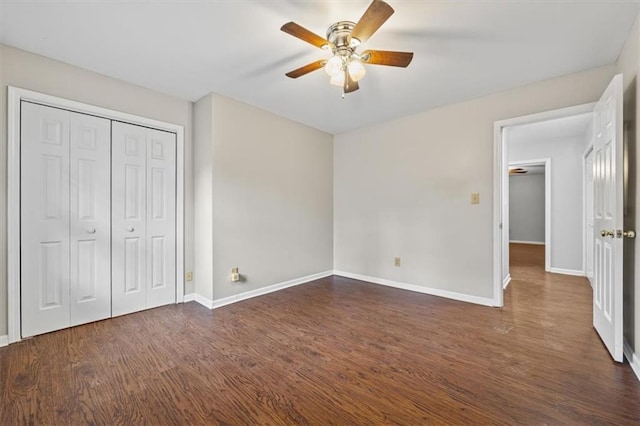 unfurnished bedroom with dark hardwood / wood-style floors, a closet, and ceiling fan