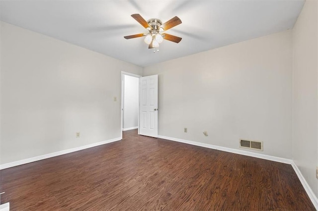 empty room featuring dark wood-type flooring and ceiling fan