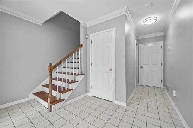 entryway with crown molding and light tile patterned flooring