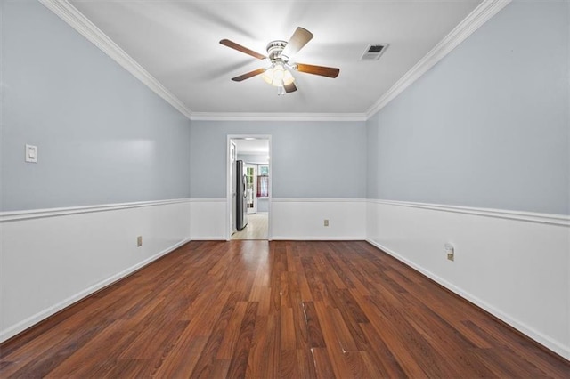 unfurnished room with ornamental molding, dark wood-type flooring, and ceiling fan