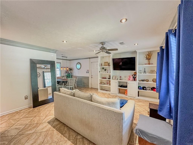 living room with ornamental molding, ceiling fan, and a textured ceiling