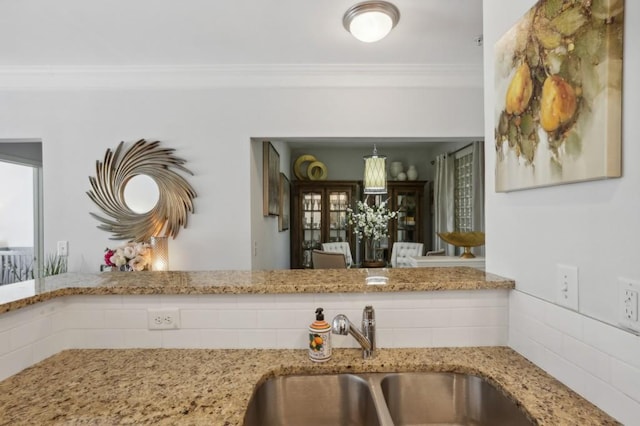 kitchen featuring ornamental molding and sink