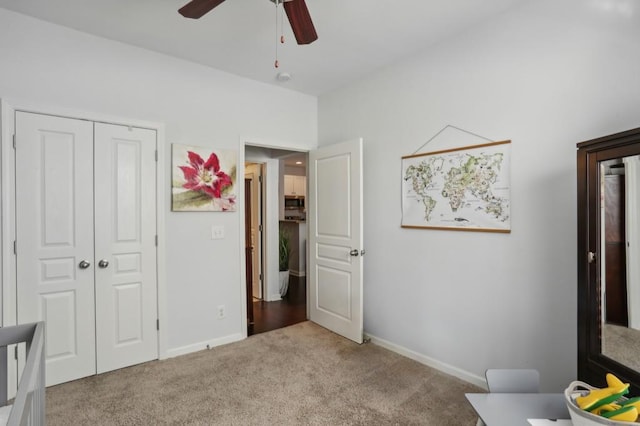 carpeted bedroom with a closet and ceiling fan