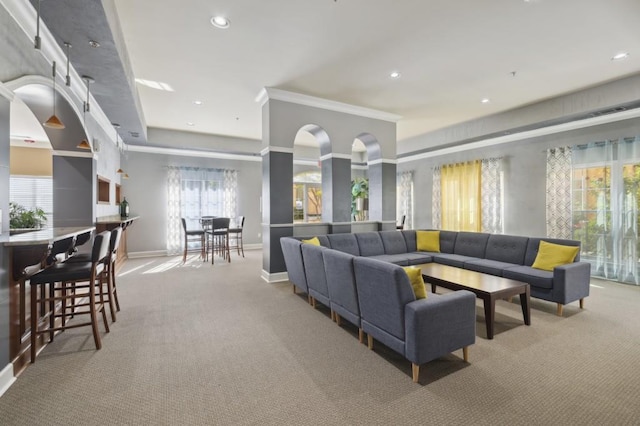 living room with ornamental molding and light colored carpet