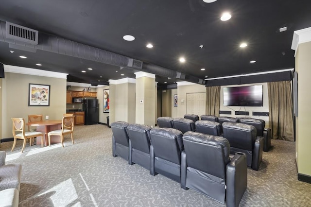 home theater room with ornamental molding and carpet flooring