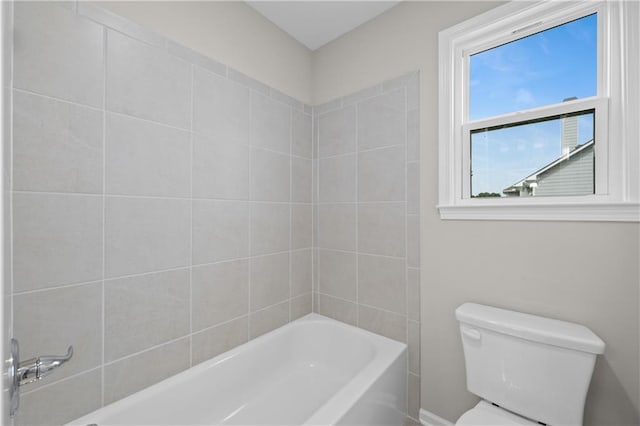 bathroom featuring tub / shower combination and toilet