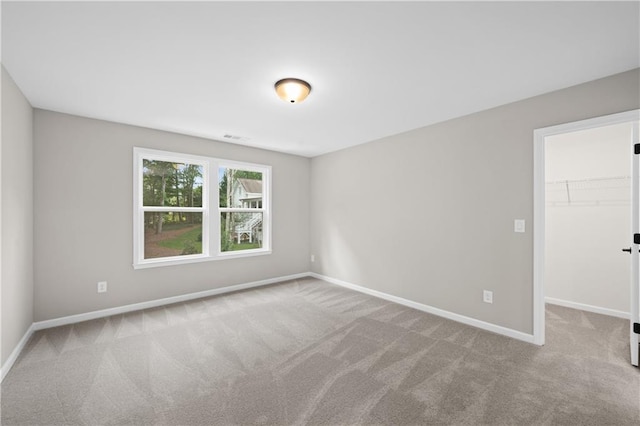 unfurnished room with carpet floors and baseboards