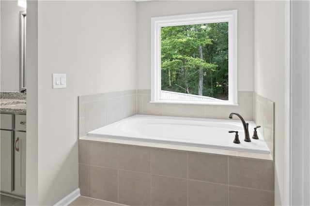 bathroom featuring vanity and a bath