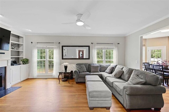 2203 Arbor Hill Rd, Canton, GA 30115 - living area with ceiling fan, light wood finished floors, crown molding, and a fireplace