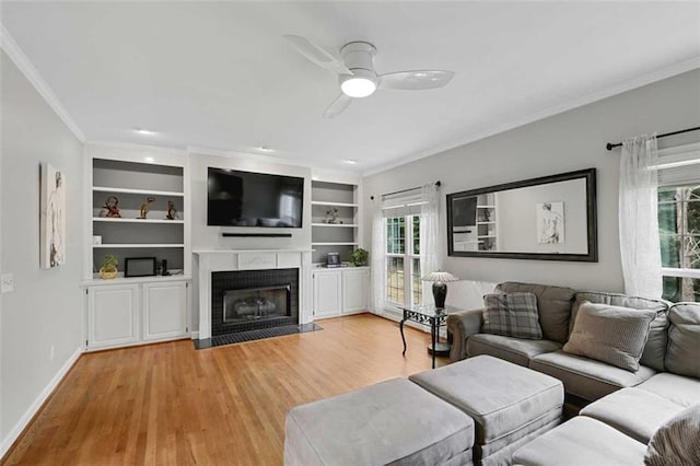 2203 Arbor Hill Rd, Canton, GA 30115 - living room featuring crown molding, a ceiling fan, plenty of natural light, a fireplace with flush hearth, and light wood-type flooring
