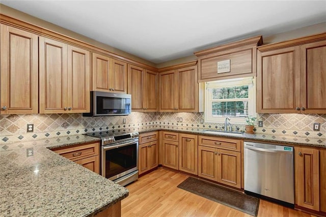 2203 Arbor Hill Rd, Canton, GA 30115 - kitchen featuring stainless steel appliances, light wood finished floors, light stone countertops, and decorative backsplash