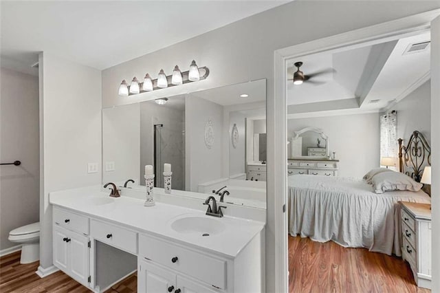 2203 Arbor Hill Rd, Canton, GA 30115 - ensuite bathroom with ceiling fan, a stall shower, wood finished floors, toilet, and double vanity