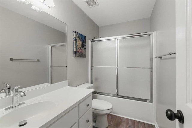 2203 Arbor Hill Rd, Canton, GA 30115 - bathroom featuring toilet, wood finished floors, vanity, and shower / bath combination with glass door